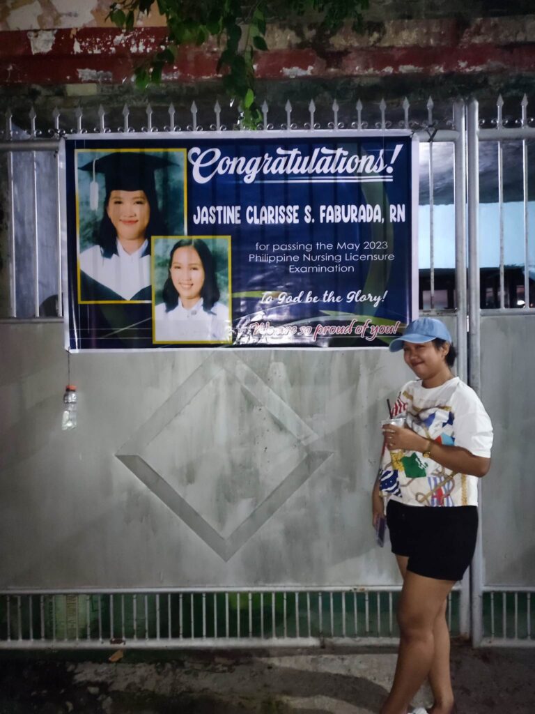 Jastine in front of banner